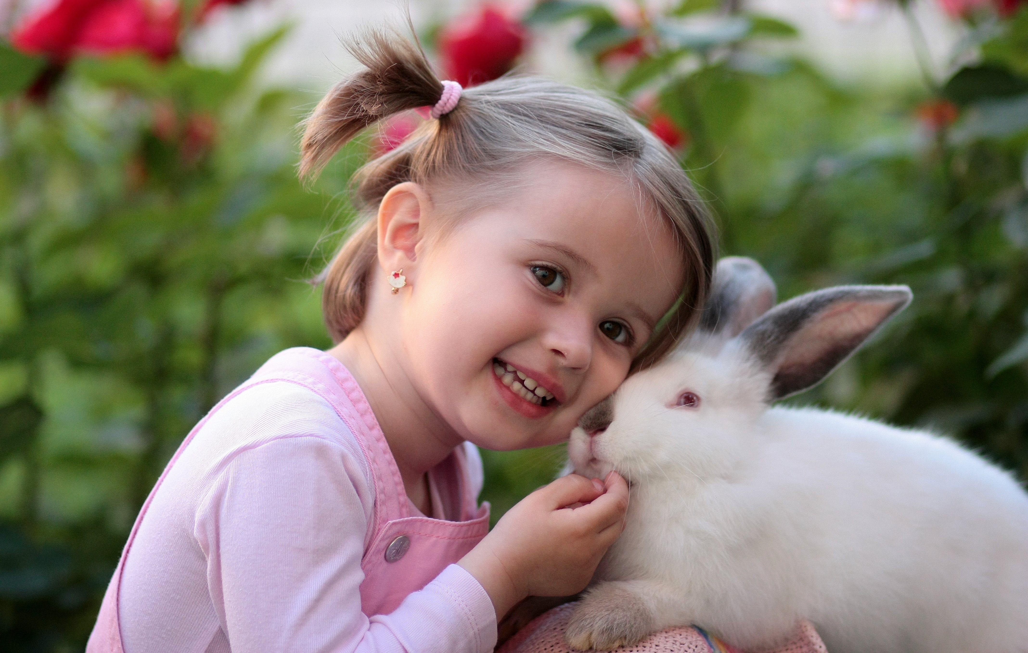 Girl playing with a rabbit in nature